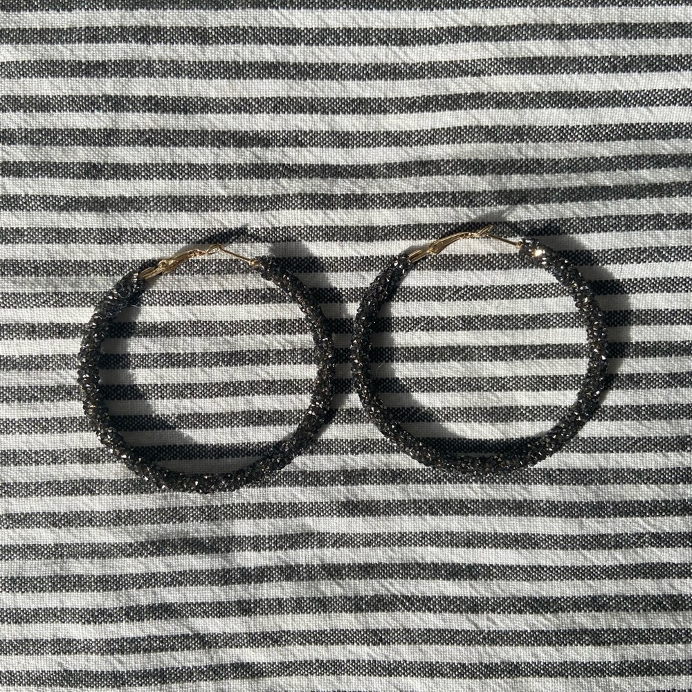 Crushed crystal hoops in gunmetal color.